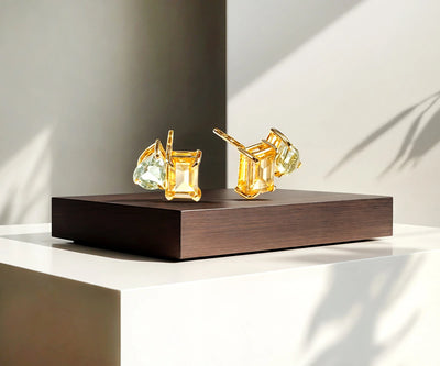 Gold Toi et Moi stud earrings with two gemstones.