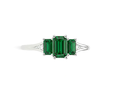 Elegant emerald and white zircon ring in sterling silver with brilliant green gemstone and shimmering halo design