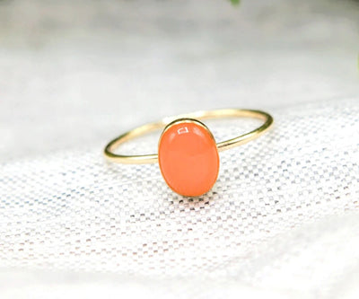 Natural peach moonstone ring with glowing red-orange hues in a slender gold-filled band, perfect for earthy elegance.