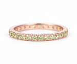 Rose gold gemstone ring featuring green stones
