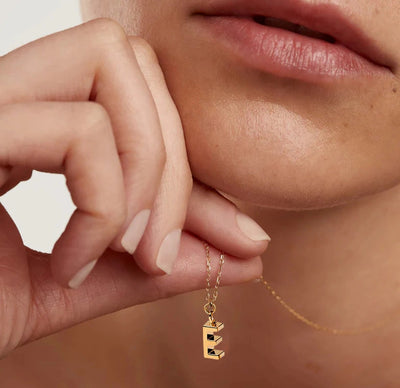 Dainty letter E necklace crafted in gold-plated brass with a 9mm x 3mm pendant and adjustable chain, perfect for layering or gifting.