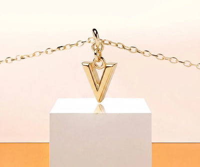 Dainty letter V necklace in gold with minimalist initial pendant on a delicate chain