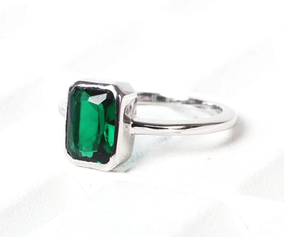 Sterling silver emerald ring with vivid green hues, perfect for adding luxury to daily wear or special events