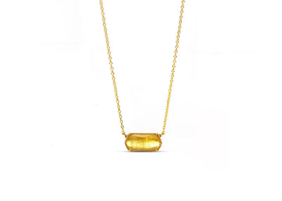 Close-up of citrine pendant with yellow gold setting