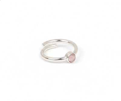 A delicate silver ring featuring a soft pink rose quartz gemstone
