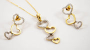 585 gold jewelry set featuring a necklace and matching earrings with triple heart designs, adorned with cubic zirconia stones and a polished gold finish.