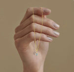 Brilliant-cut April birthstone necklace with a shimmering zircon gemstone, suspended on an adjustable gold-plated chain with lobster clasp.
