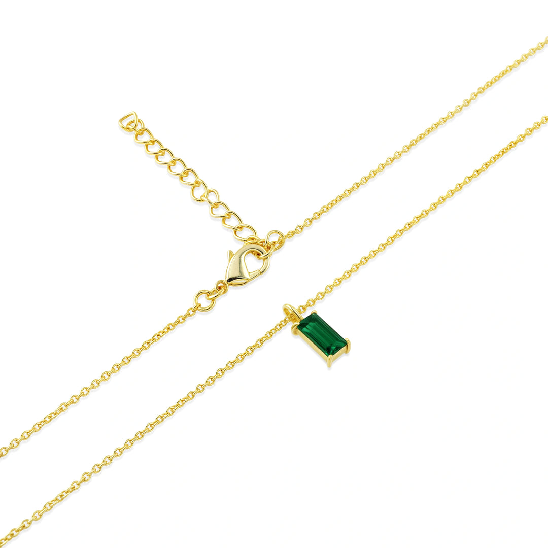 Emerald baguette pendant necklace with a vivid green birthstone set in 14K gold plating, suspended from a delicate adjustable chain with lobster clasp.