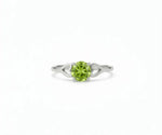 Peridot ring featuring a vibrant green gemstone set in a delicate band, blending fresh elegance with everyday sophistication
