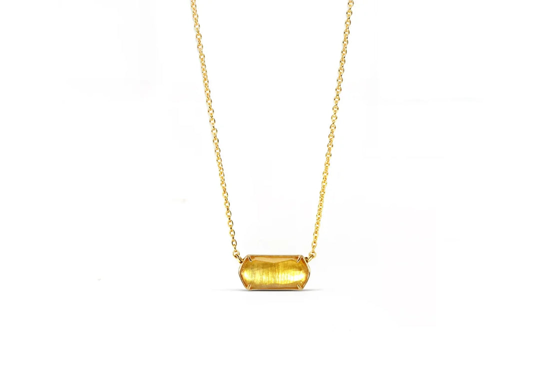 Close-up of citrine pendant with yellow gold setting