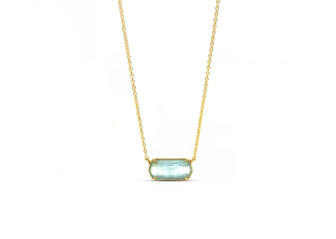 Custom-cut blue topaz pendant reflecting tranquil tones