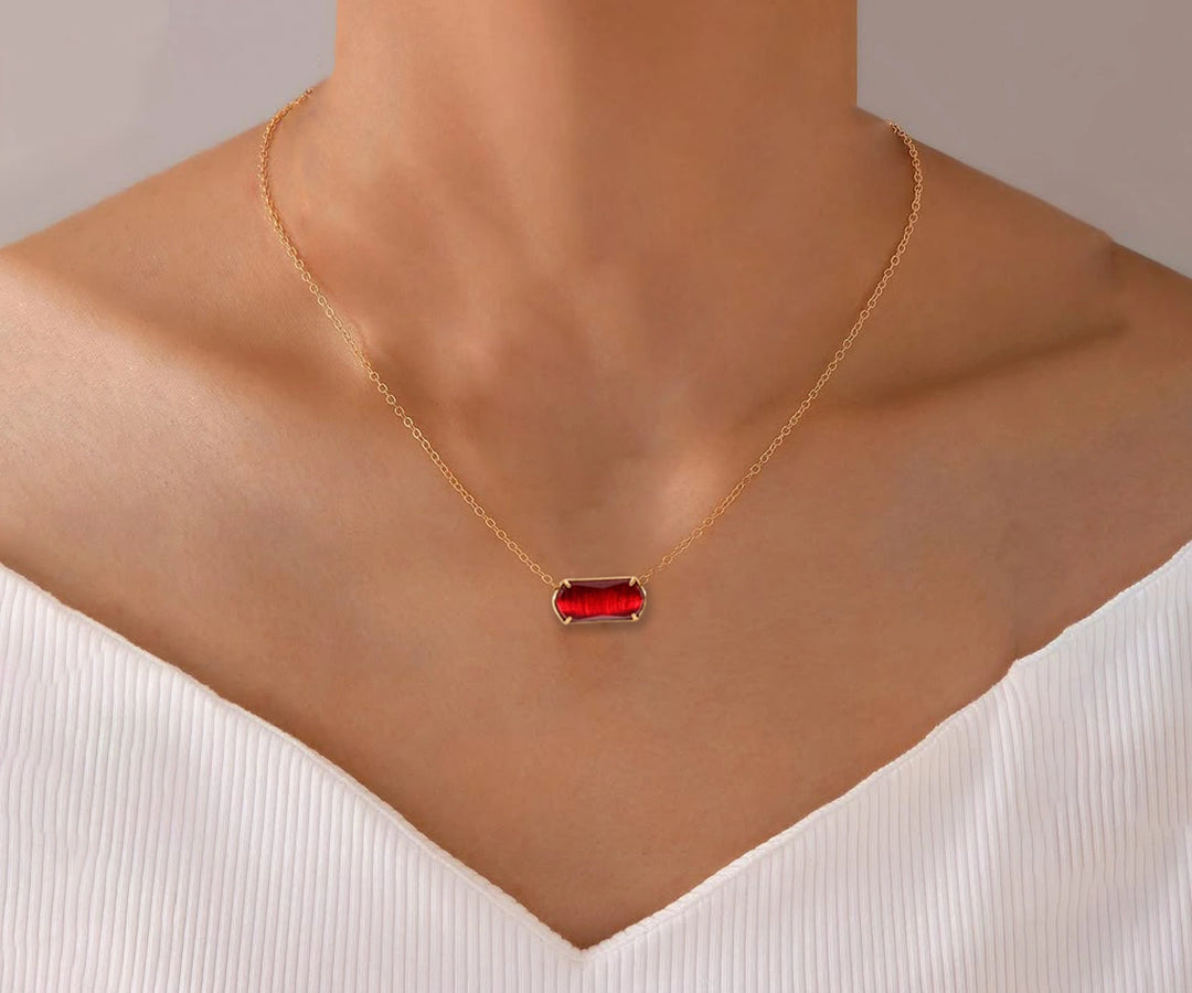 Elegant red ruby necklace displayed on white background