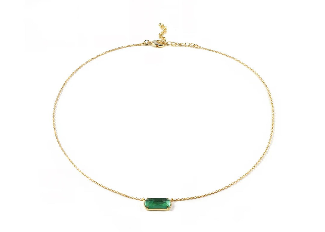 Close-up of emerald quartz stone on gold-plated chain