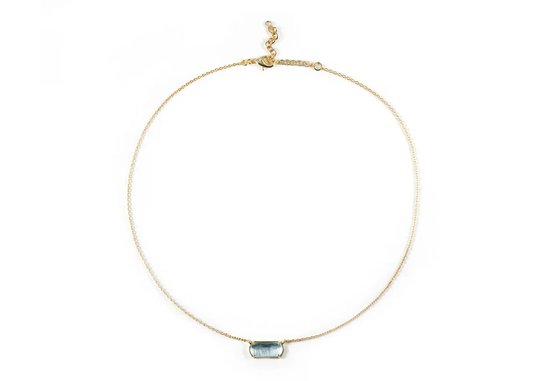 Model wearing ocean topaz necklace with summer outfit