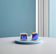18K yellow gold-plated studs with 10mm Asscher cut Blue Sapphire.