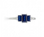 Oval sapphire ring with white zircon halo set in sterling silver offering brilliant sparkle and classic gemstone style

