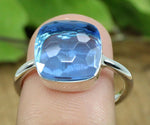 925 stamped silver ring with a brilliant blue topaz hydro gem, combining elegance and versatility

