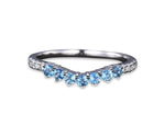 Elegant blue topaz wedding ring featuring shimmering zircon accents in a timeless sterling silver band

