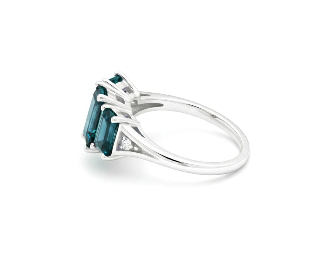 Elegant indigolite with white zircon ring featuring a rich blue-green center stone and brilliant zircon sparkle in sterling silver