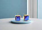 Load image into Gallery viewer, Modern square design studs with 10mm Blue Sapphire and push-back closure.
