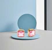 Modern square design studs with 10mm Tourmaline Bliss and secure push-back closure.