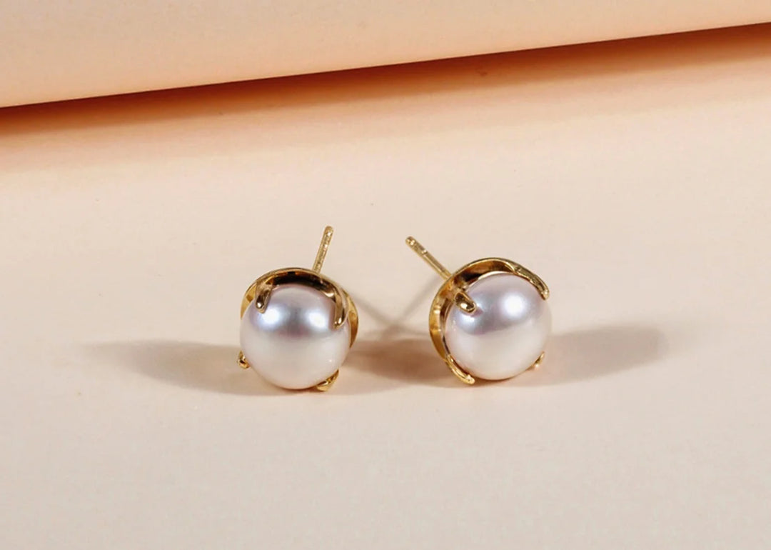 Bold pearl stud earrings with yellow gold plating