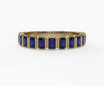 Vintage-inspired emerald cut blue sapphire engagement ring with rich blue hue and refined silver setting
