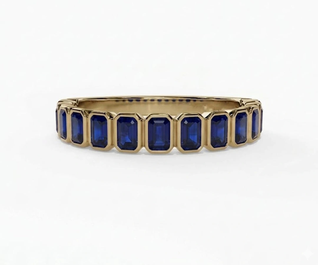 Vintage-inspired emerald cut blue sapphire engagement ring with rich blue hue and refined silver setting