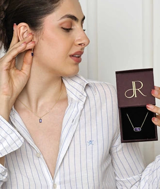 The February birthstone necklace showcases the rich purple amethyst, symbolizing clarity and calm.