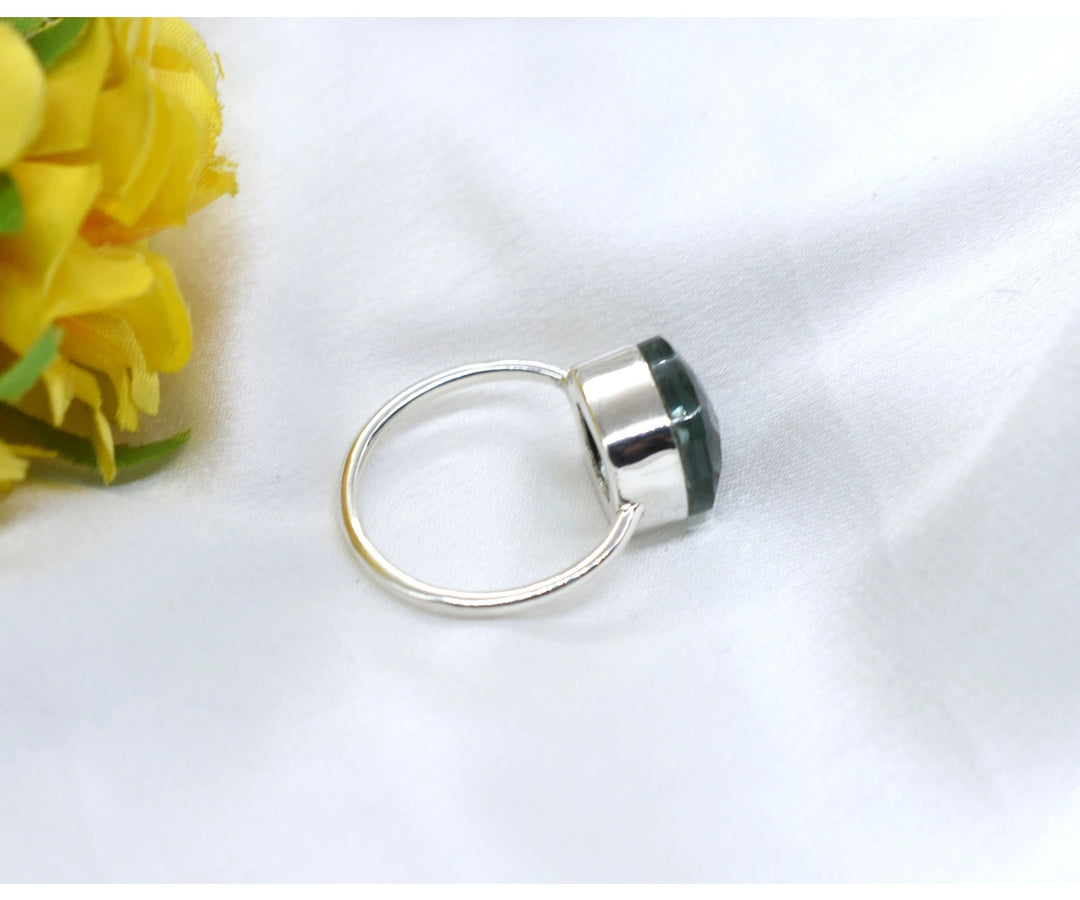 Elegant sterling silver ring featuring a vibrant lab-created green aquamarine stone for nature-inspired style


