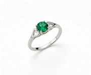 Emerald ring with a vibrant green gemstone set in a classic design that exudes elegance and timeless sophistication.