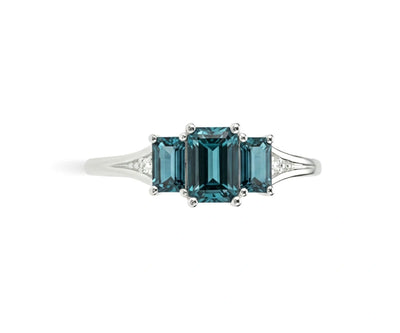 Deep blue-green indigolite gemstone ring surrounded by shimmering white zircon stones in a refined sterling silver setting