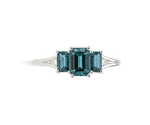 Deep blue-green indigolite gemstone ring surrounded by shimmering white zircon stones in a refined sterling silver setting
