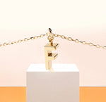 Slim and stylish initial "F" pendant necklace, adding a personal glow to any neckline.
