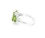 Sterling silver peridot and white zircon ring featuring a bright August birthstone center with shimmering crystal accents
