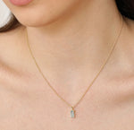 December birthstone necklace with shimmering blue topaz pendant on a delicate gold chain.

