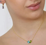 Gold pendant necklace with ocean topaz and peridot stones, perfect for layering, daily wear, and meaningful gemstone jewelry looks
