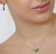 Gold pendant necklace with ocean topaz and peridot stones, perfect for layering, daily wear, and meaningful gemstone jewelry looks
