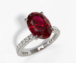 Oval lab grown ruby engagement ring with rich natural ruby stone set in a classic elegant band oval cut lab created ruby engagement ring with diamonds

