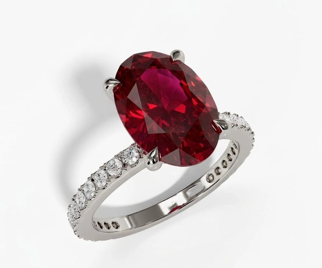 Oval lab grown ruby engagement ring with rich natural ruby stone set in a classic elegant band oval cut lab created ruby engagement ring with diamonds