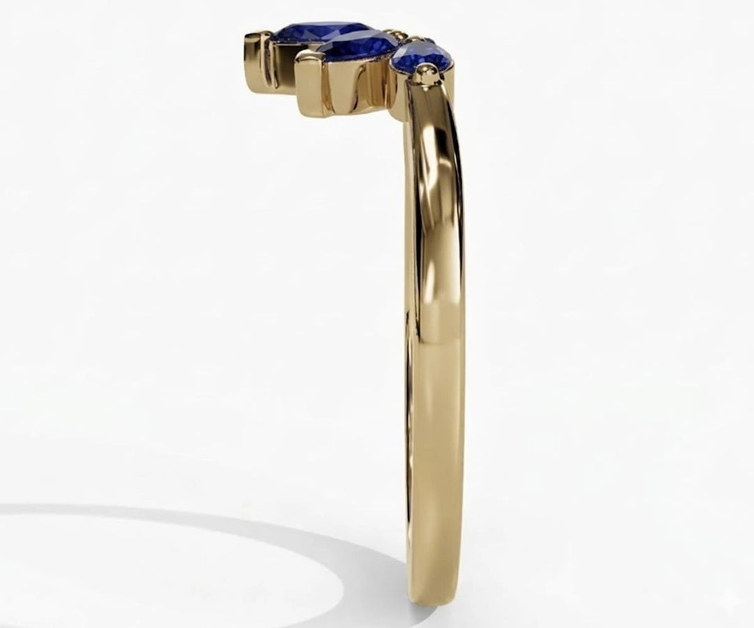Vintage-inspired sapphire ring with pear shaped blue sapphire and delicate refined setting