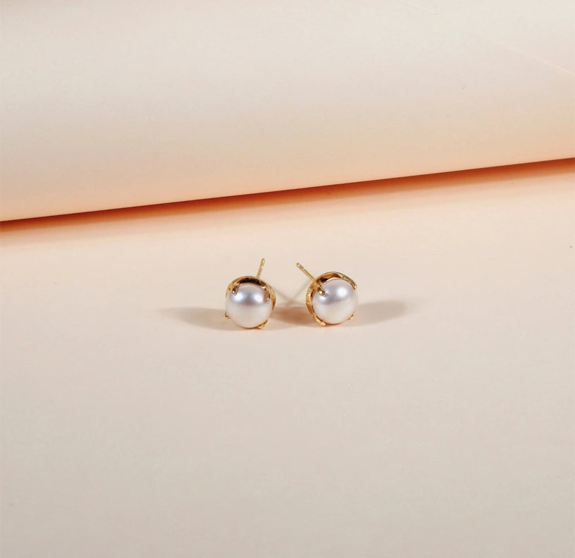 Bold pearl stud earrings with yellow gold plating