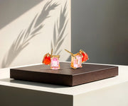 Toi et Moi gold stud earrings with emerald-cut and pear-cut stones.