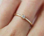 Classic zircon engagement style ring with prong setting and polished silver band
