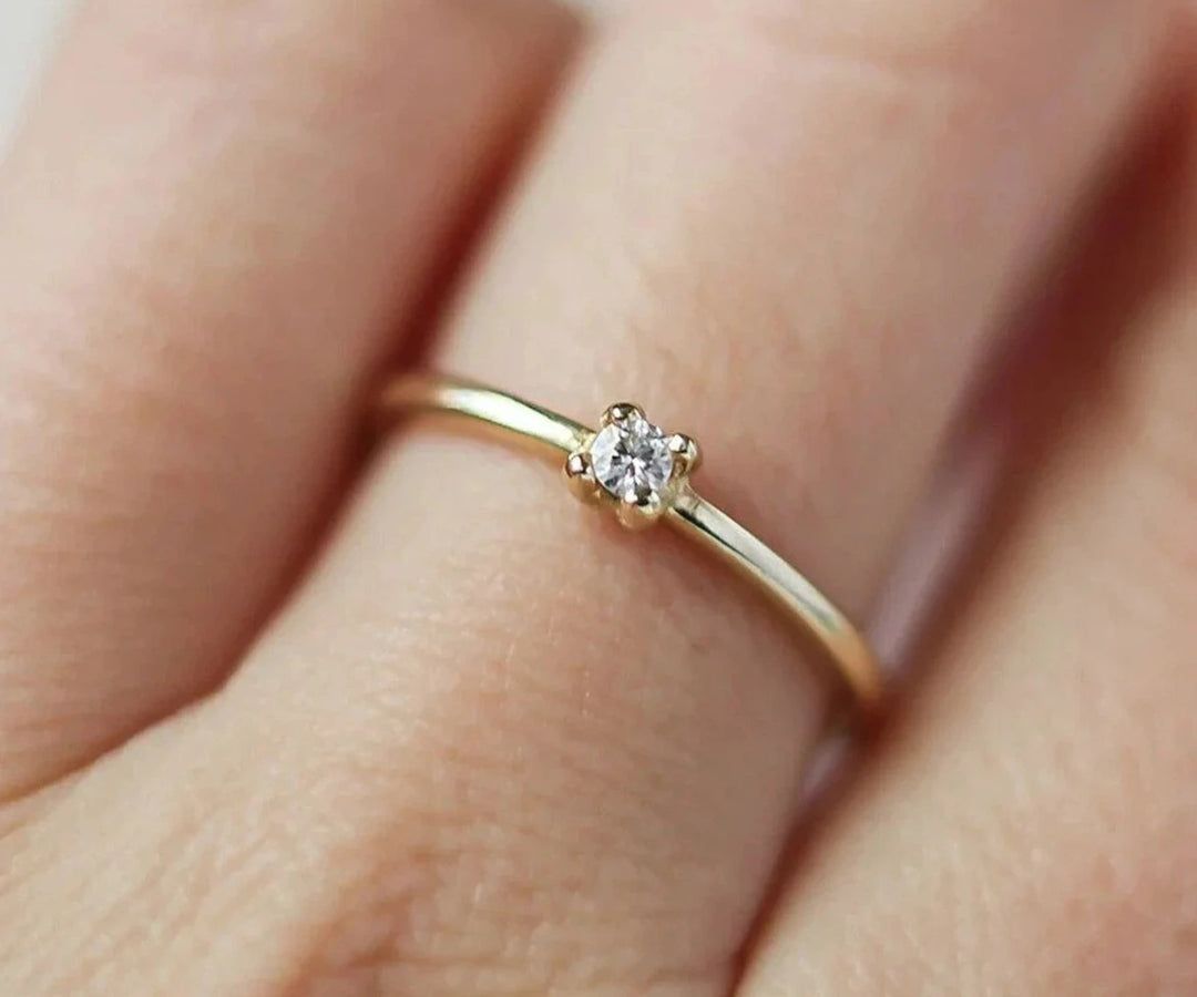 Classic zircon engagement style ring with prong setting and polished silver band