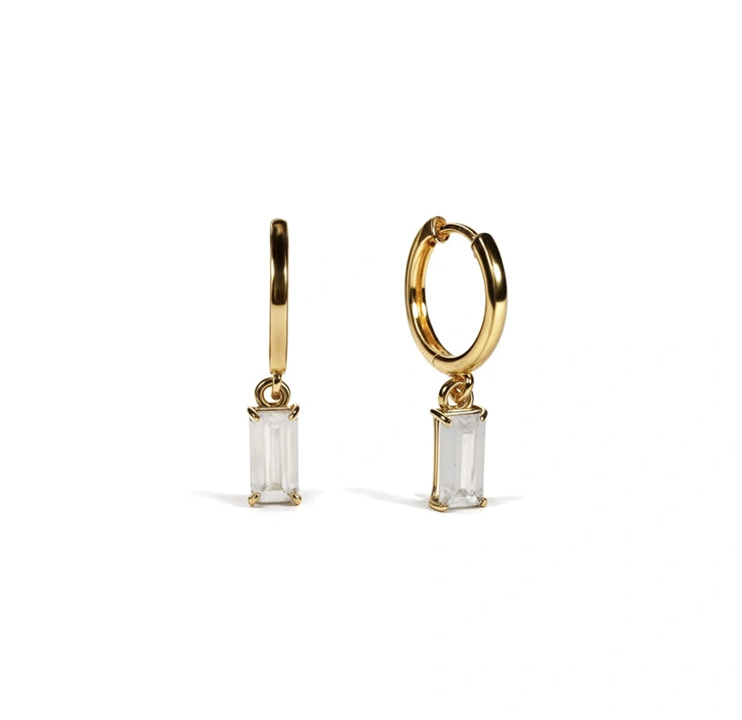 Glamorous zircon hoop earrings with dangling baguette stones, designed for subtle shimmer and standout detail.