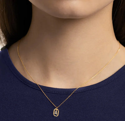An initial A gold necklace featuring a polished letter “A” pendant on a delicate gold chain, adding a personalized and elegant touch to any outfit.