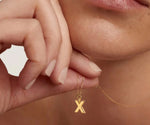 Minimalist gold X letter necklace with a dainty charm perfect for layering or gifting
