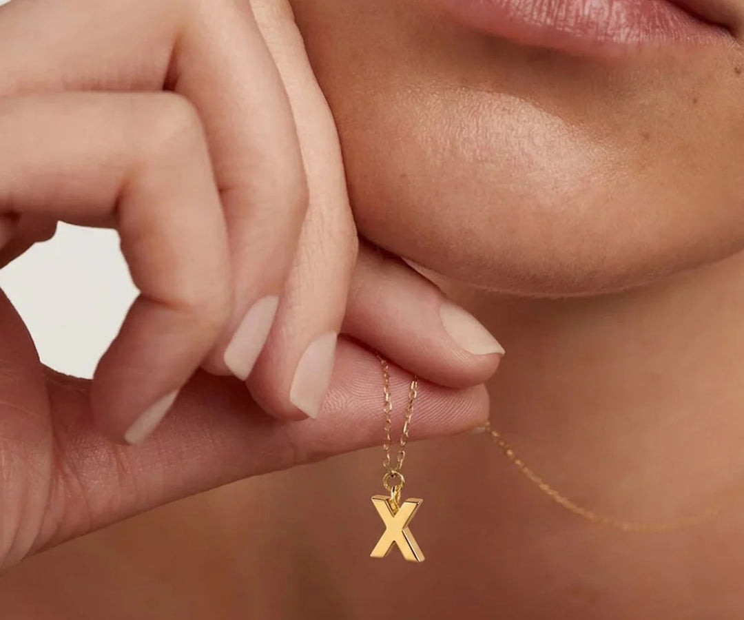 Minimalist gold X letter necklace with a dainty charm perfect for layering or gifting