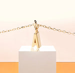 Load image into Gallery viewer, Minimalist necklace featuring an elegant gold-plated A charm on a short adjustable chain, styled for effortless sophistication and daily wear.
